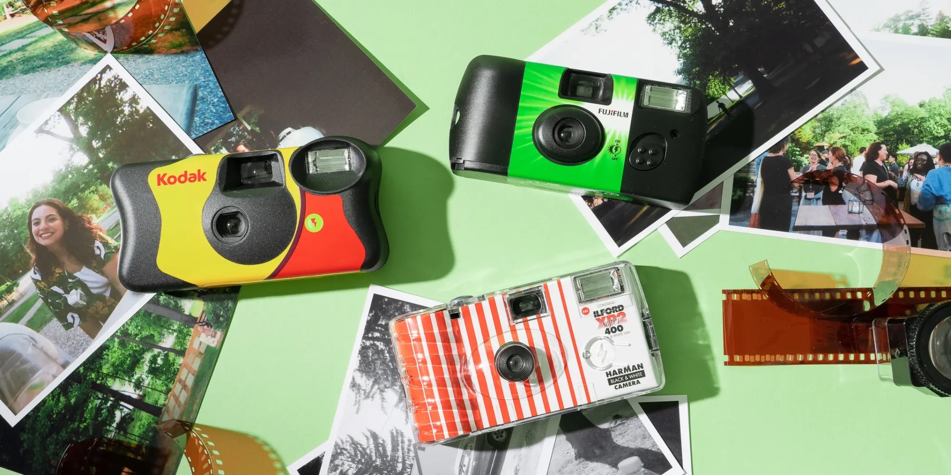 Kodak, Fujifilm and Ilford disposable cameras with printed photos and film strips on a green background