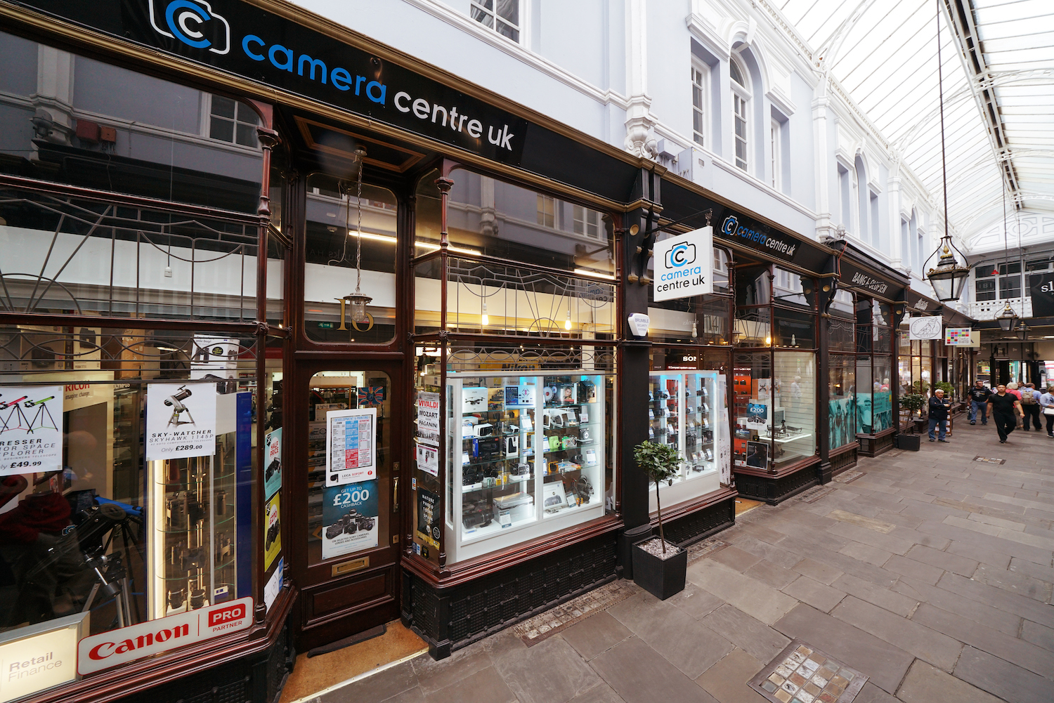 Vintage film cameras, lenses and boxes of film on the shelves of Camera Centre UK's Cardiff shop